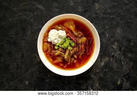 Borscht Soup In A White Bowl On Dark Gray Background. Top View. Famous Traditional Ukrainian And Rus