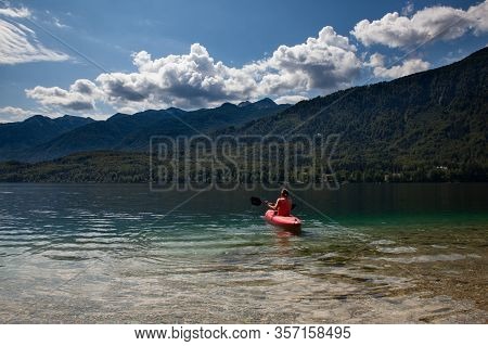 Girl Kayaking In The Scenic Bohinj Lake, Slovenia