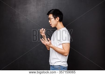 Technology, Gadgets And People Concept. Profile Portrait Of Young Asian Male Student Record Voice Me