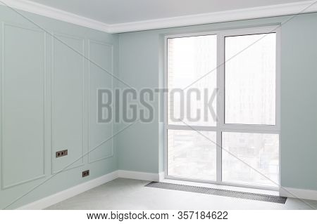 Empty Elegant Mint Colored Room With Boiserie On The Walls And Panoramic Windows With A Convector In