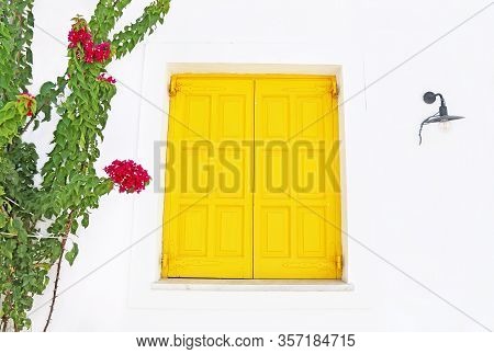 Traditional Old Yellow Window With Bougainvillea Flowers At Koufonisia Islands Greece