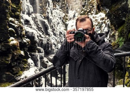 Tourist with a camera in Bordalsgjelet gorge in Voss, Norway.