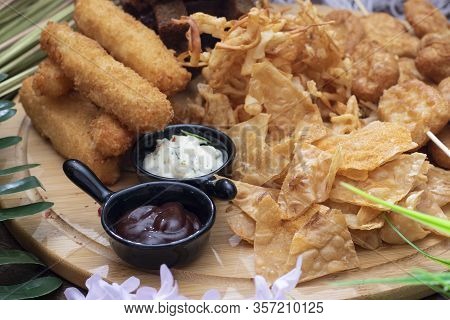 Salty Snacks. Deried Pretzels, Chips, Crackers And Two Sauces