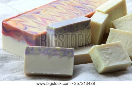 Cold Process Soaps In Block And Bar Form On Linen Background
