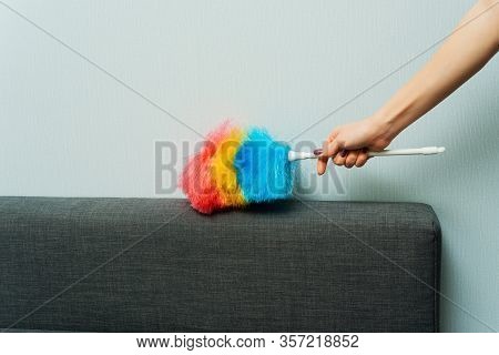 Housewife Wipes Dust With A Dust Brush During Spring Cleaning At Home. Household Chores And Housekee