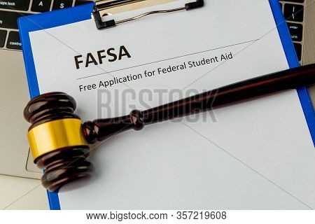 Fafsa. Student Aid Statement Form And Money On The Tablet.