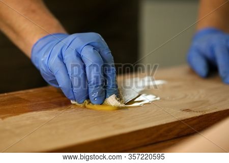 Gloved Carpenter Does Hydrothermal Treatment Wood. Carpenter Understands Wood Species And Knows How 