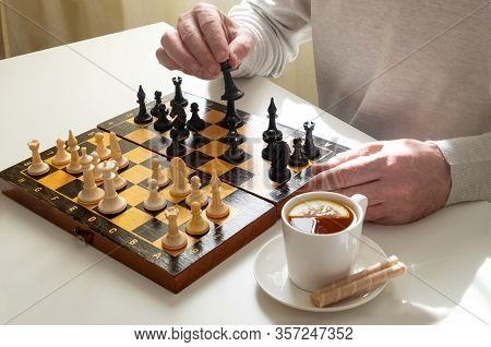 A Middle-aged Man Or A Pensioner Plays Chess In Quarantine Or In His Spare Time. Quarantine, Covid-1