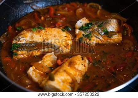 Hake Fillet Stew, Cooking In A Tomato Sauce With Red Pepper Sauce, With Some Parsley Leaves To Garni
