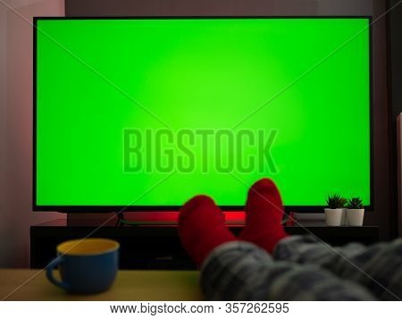 Feet Up On The Table In Front Of Green Screen Tv Televison Chroma Key At Home