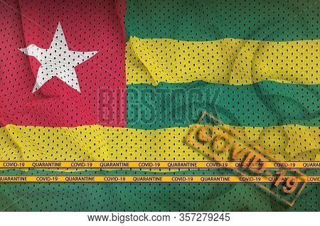 Togo Flag And Orange Covid-19 Stamp With Border Tape. Coronavirus Or 2019-ncov Virus Concept