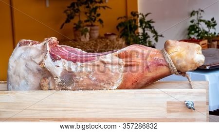 Slicing Jamon Mounted On A Hamoner, Jamon Serrano Dish Of Spanish National Cuisine. Hamon Pork Leg O