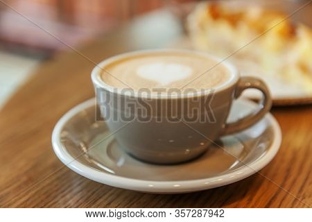 Coffee Cup Fresh Cream Organic Cappuccino On Table In Cafe. Latte Macchiato Drink In Glass Close Up.