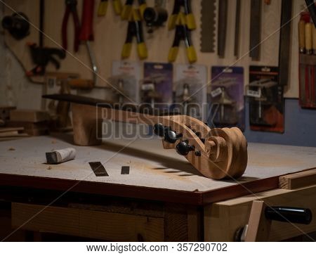 Cello Neck Finishing Process On The Workbench In Atelier