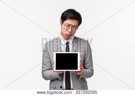 Waist-up Portrait Of Gloomy And Upset Young Asian Man Losing Online Competition, Didnt Win Prize, Ha