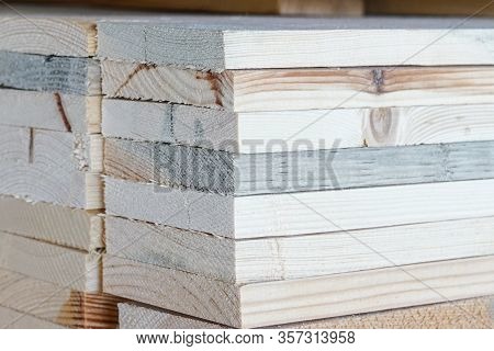 Pile Of Pine Wood In A Warehouse Or Storage Room. Wood Proceesing, Wood For Furniture