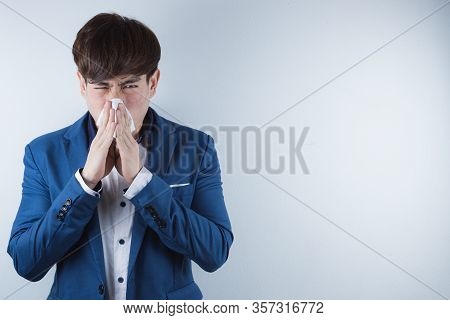 The Business Man Blowing A Nose To Tissue Paper From Coronavirus And Pm 2.5. Coronavirus And Air Pol