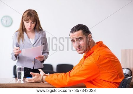 Young man meeting with advocate in pre-trial detention