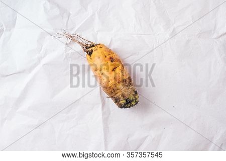Ugly Misshapen Carrots On Wooden Background. Concept Of Zero Waste Production. Top View. Copy Space.