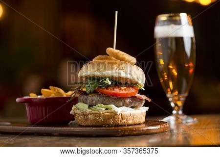 Burger Of Beef Meat With Melted Chedar Cheese, Bacon,tomato, Rocket Salad With Fried Onion And Spicy