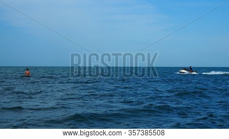 Man Is Riding A Jet Ski At Very High Speed With Spray Behind. Powerboat Go Fast