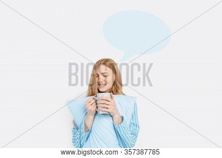 A Beautiful Girl In Striped Pajamas, Dreaming About Something In Her Thoughts, With A Cup In Her Han