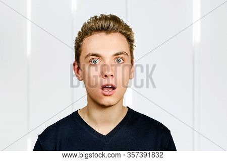 Portrait Of Young Surpriced Man With Pompadour Hairstyle