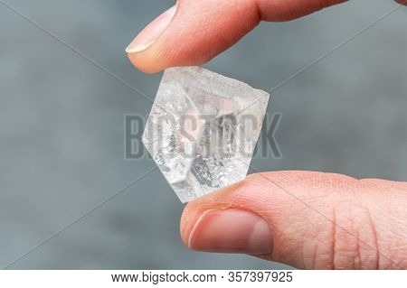 Raw Diamond Holding Big Dob In Hand Between Thumb And The Forefinger