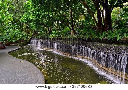Small Pond With Water Cacade In The Singapore Botanic Garden
