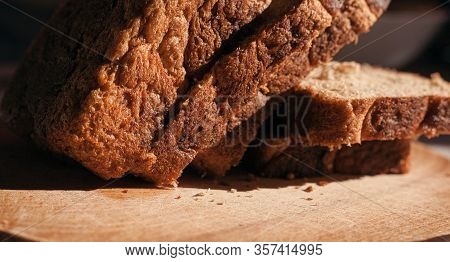 Sliced ​​black Rye Bread On A Wooden Board. Brick-shaped Bread.