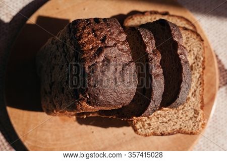 Sliced ​​black Rye Bread On A Wooden Board. Brick-shaped Bread.