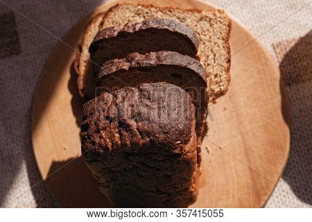 Sliced ​​black Rye Bread On A Wooden Board. Brick-shaped Bread.