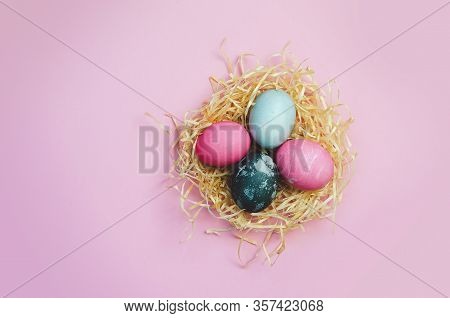 Easter Eggs And Nestle With Colorful Eggs On Pink Background