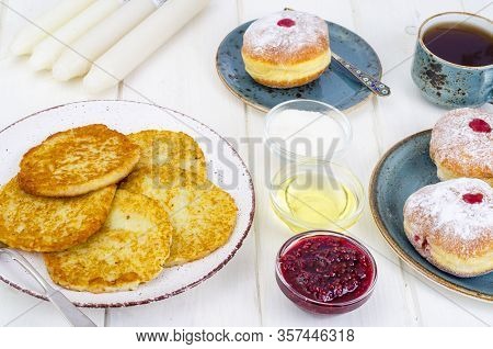 Concept And Background Jewish Holiday Hanukkah. Traditional Food Doughnuts And Potatoes Pancakes Lat