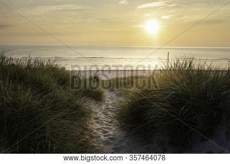 Beach Sunset On Sylt Island At The North Sea, Germany. Sand Footpath Through Tall Grass. Horizon Ove