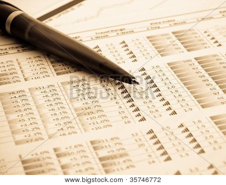 caneta e indicadores financeiros