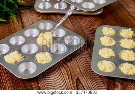 Cooking Brazilian Cheese Bread Chipa In Baking Pan With Spoon.