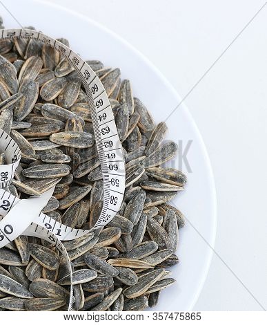 Dry Roasted And Salted Sunflower Seeds On A White Background,