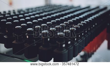 Many Gel Nail Polish Black Bottles Background. Materials For Gel Nail Procedure. Bottles With Gel-va