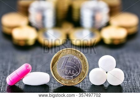 Medical Pills Or Tablets Next To Coins. Concept Of Federal Government Costs With Public Health.