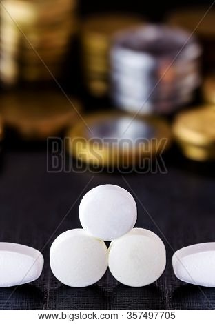 Medical Pills Or Tablets Next To Coins. Concept Of Federal Government Costs With Public Health.