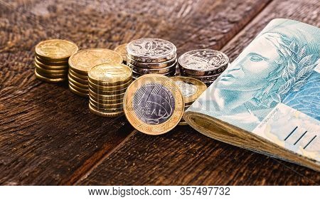 One Real Coin And Gold Bars. Concept Of Appreciation Of The Brazilian Currency In The Stock Market.