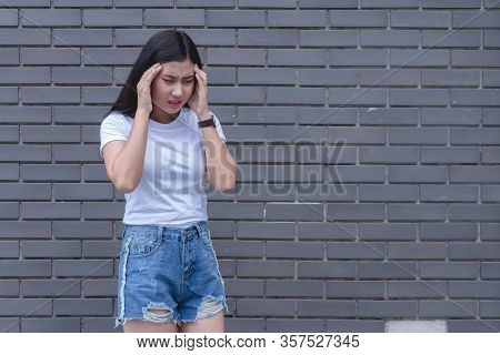 Stressd Woman Having Migraine Headache Feeling Pain.
Sick Asian Female Holding Hands On Head With Ba