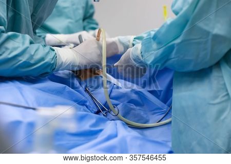 Team Of Professional Doctors Performing Operation In Surgery Room