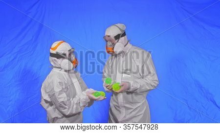 Doctor In Respirator Show A Virus Model. Slow Motion. Woman Wearing Protect Medical Aerosol Spray Pa