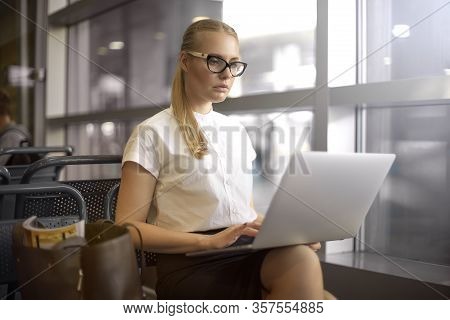 Female In Spectacles Clever Employer Searching Resume On Web Site Via Laptop Computer While Sitting 