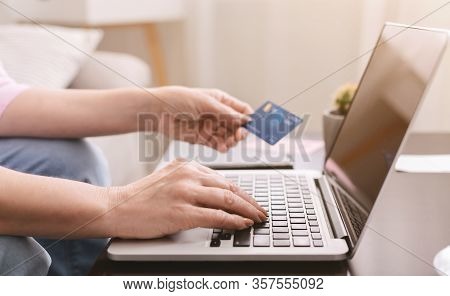 Self-isolation At Home. Senior Woman Hands Shopping Online At Home With Bank Card And Laptop, Close 