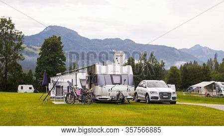 Lofer, Austria - May 28, 2018: Autocampers Are On Campground Parking In The Alpine Mountains