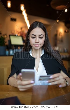 Gorgeous Woman Dressed In Fashionable Clothes Online Ordering Via Cellphone Using Credit Debit Card 