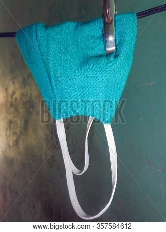 A Green Mask Of Cloths Kept For Dry After Washing On Home For Avoid Corona Virus